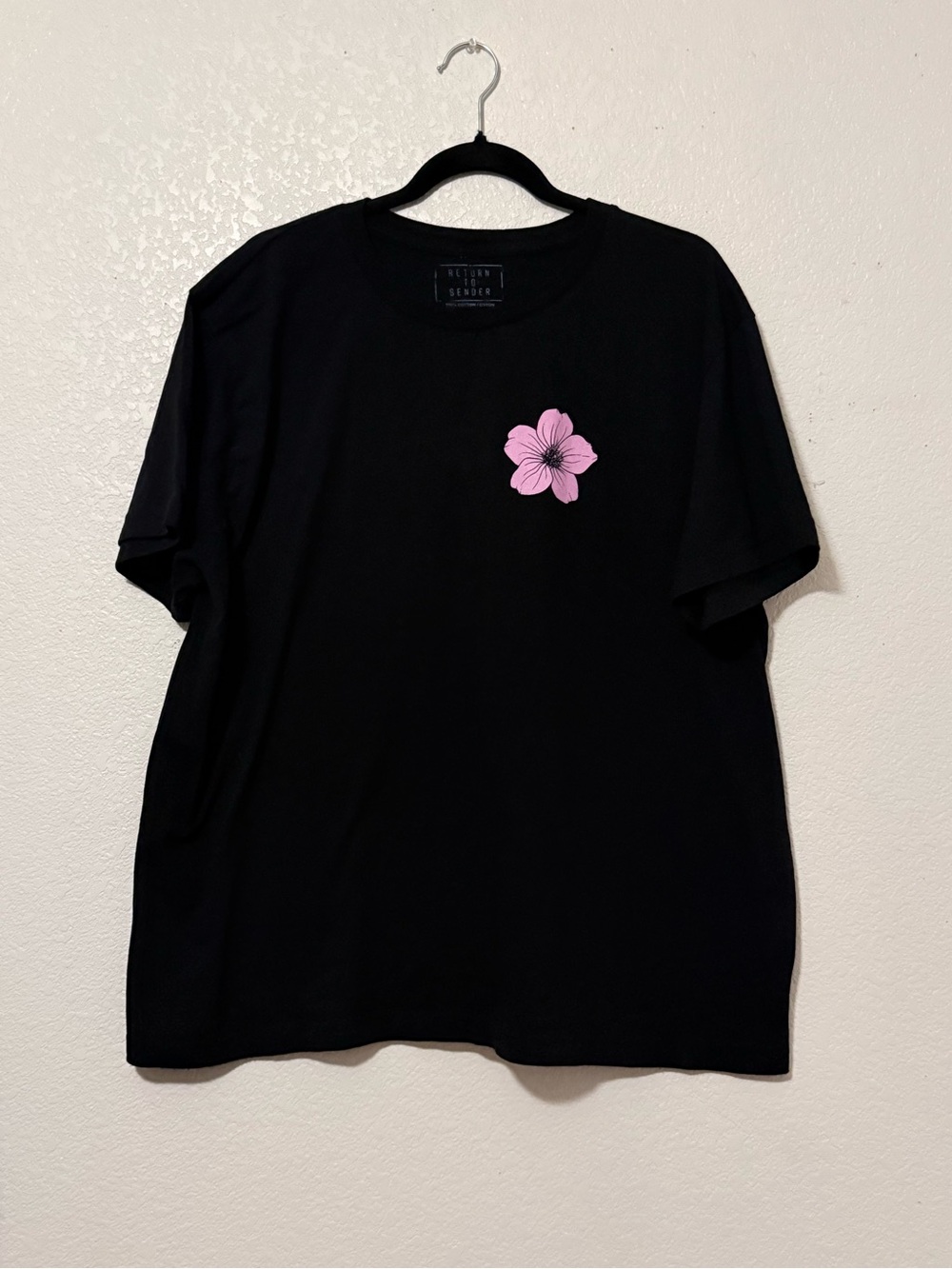 Return to sender Black Tee with Pink Floral Chest Graphic